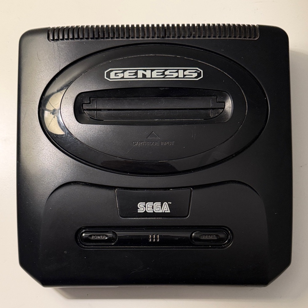 Sega Genesis Mk-1631 console, includes all cables, controller, and games.